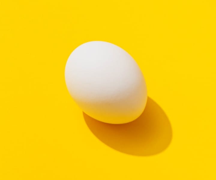 an-egg-with-a-yellow-background